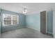 This bedroom features a ceiling fan, natural light from a window, and light blue walls at 309 Oakwood Ct, Lake Mary, FL 32746