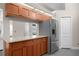 Kitchen showcasing stainless steel refrigerator, light wood cabinetry and granite countertop at 309 Oakwood Ct, Lake Mary, FL 32746