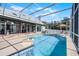 Inviting screened pool features clear blue water and ample seating in a private backyard oasis at 309 Oakwood Ct, Lake Mary, FL 32746