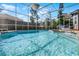 Enclosed pool with crystal clear water surrounded by a screened enclosure and wood deck at 309 Oakwood Ct, Lake Mary, FL 32746