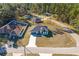 Aerial view of a single-story home with a spacious yard surrounded by mature trees at 325 Marion Oaks Golf Way, Ocala, FL 34473