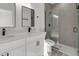 Modern bathroom with dual sinks, white cabinets and a glass-enclosed shower at 325 Marion Oaks Golf Way, Ocala, FL 34473