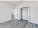Bright bedroom featuring wood-look flooring, closet, neutral color palette and an open floor plan at 325 Marion Oaks Golf Way, Ocala, FL 34473
