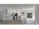 Modern kitchen features white cabinets, stainless steel appliances, an island with pendant lighting and wood-look floors at 325 Marion Oaks Golf Way, Ocala, FL 34473