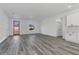 Open-concept living room with wood-look flooring, natural light, and access to the kitchen at 325 Marion Oaks Golf Way, Ocala, FL 34473