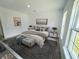 Serene main bedroom featuring a luxurious bed, stylish decor, and scenic window views at 325 Marion Oaks Golf Way, Ocala, FL 34473