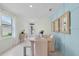 Dining area with light-toned table and bench, view to entryway at 3516 Fort Mellon Ln, Sanford, FL 32773