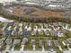 Scenic aerial view of a residential neighborhood with lush surroundings and a pond nearby at 3773 Moon Dancer Pl, St Cloud, FL 34772