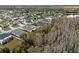 An aerial view of a home in a quiet neighborhood with a pond nearby at 3773 Moon Dancer Pl, St Cloud, FL 34772