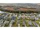 Aerial view of a blue house in a neighborhood surrounded by green trees and other houses at 3773 Moon Dancer Pl, St Cloud, FL 34772