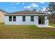 Exterior of the home featuring grass, a patio, and sliding glass doors at 3773 Moon Dancer Pl, St Cloud, FL 34772