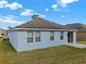 Home's backyard showcasing the exterior, grass, and sliding doors at 3773 Moon Dancer Pl, St Cloud, FL 34772