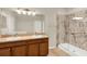 Bathroom with double sink vanity and tiled walk-in shower with glass door at 3773 Moon Dancer Pl, St Cloud, FL 34772