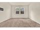 Bright carpeted bedroom with dual windows and a wall-mounted television bracket at 3773 Moon Dancer Pl, St Cloud, FL 34772