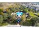 An aerial view shows a community pool surrounded by palm trees and landscaped grounds at 3773 Moon Dancer Pl, St Cloud, FL 34772