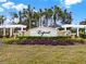 A landscaped sign displays 'Esprit' under a blue sky and tall palm trees at 3773 Moon Dancer Pl, St Cloud, FL 34772