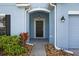 Inviting front porch with decorative plants and a stylish overhead light fixture at 3773 Moon Dancer Pl, St Cloud, FL 34772