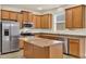 Well-equipped kitchen featuring stainless steel appliances and granite countertops with island at 3773 Moon Dancer Pl, St Cloud, FL 34772