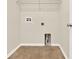 Empty laundry room provides a blank canvas for storage and organization with tile floors and utility connections at 3773 Moon Dancer Pl, St Cloud, FL 34772