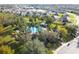 An aerial view of a community pool surrounded by trees and neighborhood homes at 3773 Moon Dancer Pl, St Cloud, FL 34772