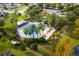 Overhead view of a community pool surrounded by trees and lawn chairs at 3773 Moon Dancer Pl, St Cloud, FL 34772