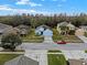 A neighborhood street shows three well-maintained houses and landscaped yards under a cloudy blue sky at 3773 Moon Dancer Pl, St Cloud, FL 34772