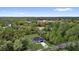 Aerial view of house surrounded by green landscape and a nearby lake at 42 Fisher Way Trak, Ocklawaha, FL 32179