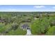 Aerial view of home nestled among lush greenery and mature trees at 42 Fisher Way Trak, Ocklawaha, FL 32179