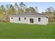 Home featuring a large green backyard with sliding glass doors at 42 Fisher Way Trak, Ocklawaha, FL 32179