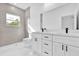 Bathroom with white vanity, dual sinks, stone countertop and tile shower at 42 Fisher Way Trak, Ocklawaha, FL 32179