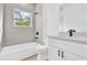 Bright bathroom featuring a tub with shower and gray tile surround at 42 Fisher Way Trak, Ocklawaha, FL 32179