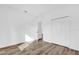 Bedroom with closet features wood-look floors and neutral wall color at 42 Fisher Way Trak, Ocklawaha, FL 32179