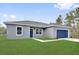 Single-story home featuring a manicured lawn, gray exterior, and blue door, providing a welcoming curb appeal at 42 Fisher Way Trak, Ocklawaha, FL 32179