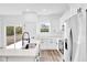 Bright kitchen features white cabinets, modern appliances, and a large sink at 42 Fisher Way Trak, Ocklawaha, FL 32179