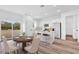 Dining room and kitchen featuring white cabinetry, stainless steel appliances, and an eat-in island at 42 Fisher Way Trak, Ocala, FL 34473