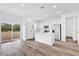 Bright kitchen features white cabinets, stainless steel appliances, breakfast bar, and wood-look flooring at 42 Fisher Way Trak, Ocklawaha, FL 32179