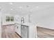 Bright open kitchen with stainless steel dishwasher and large island sink at 42 Fisher Way Trak, Ocklawaha, FL 32179