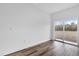 Open living room featuring sliding glass doors and wood-style flooring at 42 Fisher Way Trak, Ocklawaha, FL 32179