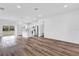 Bright, open floorplan featuring hard surface flooring, a kitchen island, and ample natural light at 42 Fisher Way Trak, Ocklawaha, FL 32179
