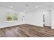 Living room featuring wood-look floors, natural light, and neutral color palette at 42 Fisher Way Trak, Ocklawaha, FL 32179