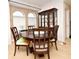 Round dining table with six chairs, situated near a china cabinet at 4401 Messina Dr, Lake Mary, FL 32746