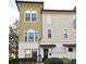 Front view of a tan townhome with a dark brown door and white trim at 4401 Messina Dr, Lake Mary, FL 32746