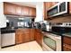 Kitchen features stainless steel appliances and dark wood cabinets at 4401 Messina Dr, Lake Mary, FL 32746