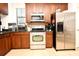 Stainless steel appliances and dark wood cabinets in this kitchen at 4401 Messina Dr, Lake Mary, FL 32746