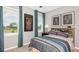 Bedroom with a full-size bed and teal colored accents at 5702 Gingham Dr, Kissimmee, FL 34758