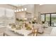 Bright dining room with white table, and access to the living room and kitchen at 5702 Gingham Dr, Kissimmee, FL 34758