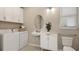 Laundry room with washer, dryer, sink, and additional storage at 5702 Gingham Dr, Kissimmee, FL 34758
