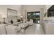 Relaxing living room with light-colored furniture and access to a patio at 5702 Gingham Dr, Kissimmee, FL 34758