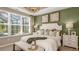 Main bedroom with a king-size bed and large windows overlooking the backyard at 5702 Gingham Dr, Kissimmee, FL 34758