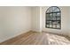 Inviting bedroom with an arched window that allows for natural light to come in, and modern floors at 6031 Grand Coulee Rd, Orlando, FL 32810